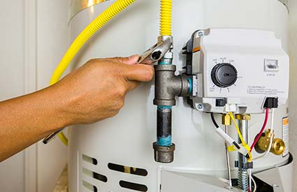 R.J. Parins Plumbing and Heating licensed and insured plumbers installs gas line on hot water heater.