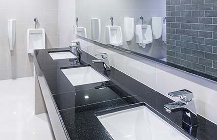 Set of bathroom sinks in a commercial bathroom installed by RJ Parins Plumbing & Heating in Green Bay WI.